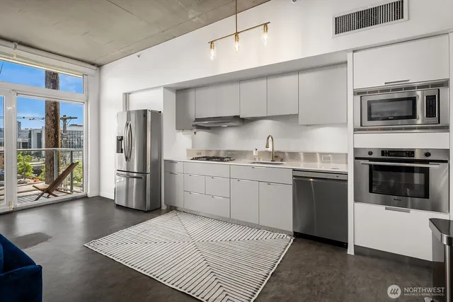 a kitchen with a sink stainless steel appliances and cabinets