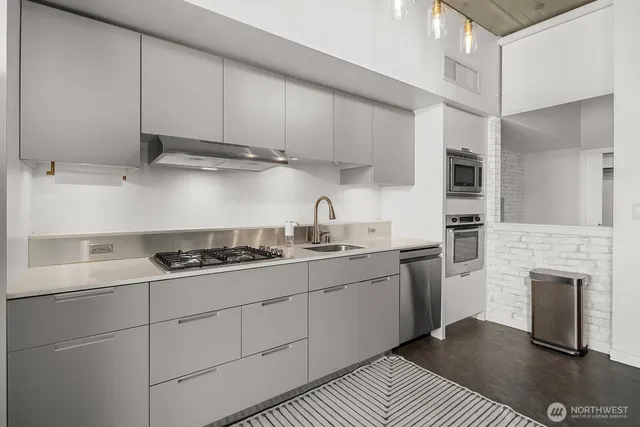a kitchen with stainless steel appliances granite countertop a sink and cabinets