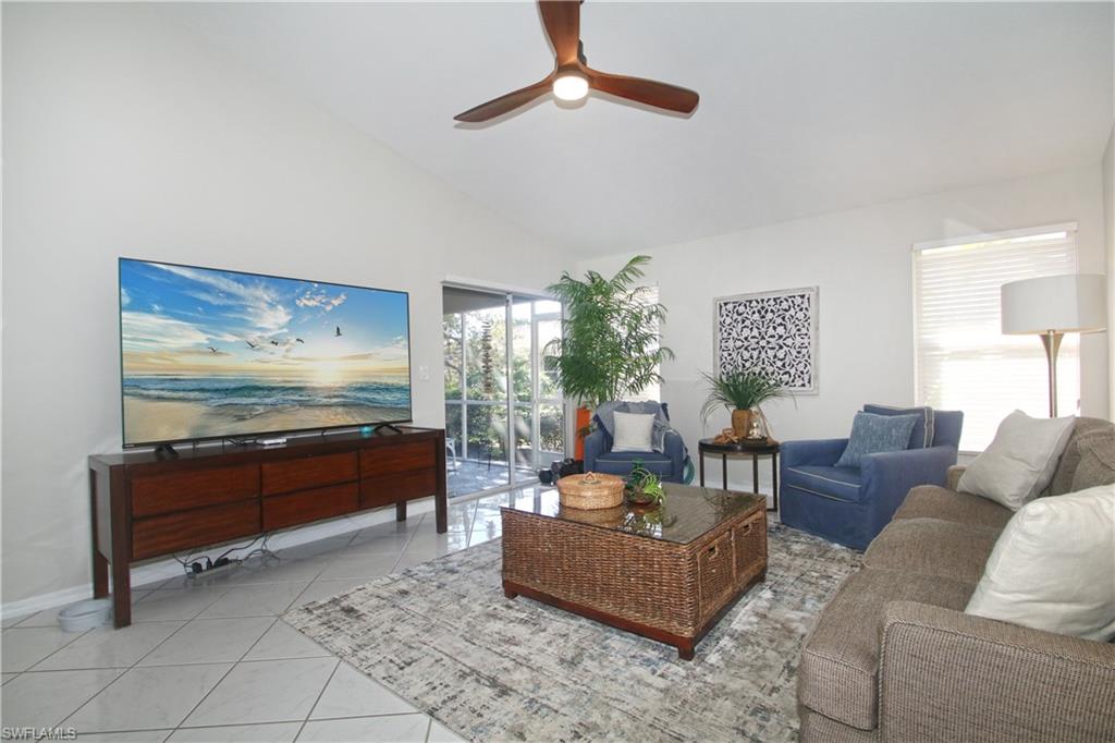 370 Emerald Bay Circle, Unit N8 Naples, FL 34110 - Photo 1 of 24 a living room with furniture and a flat screen tv