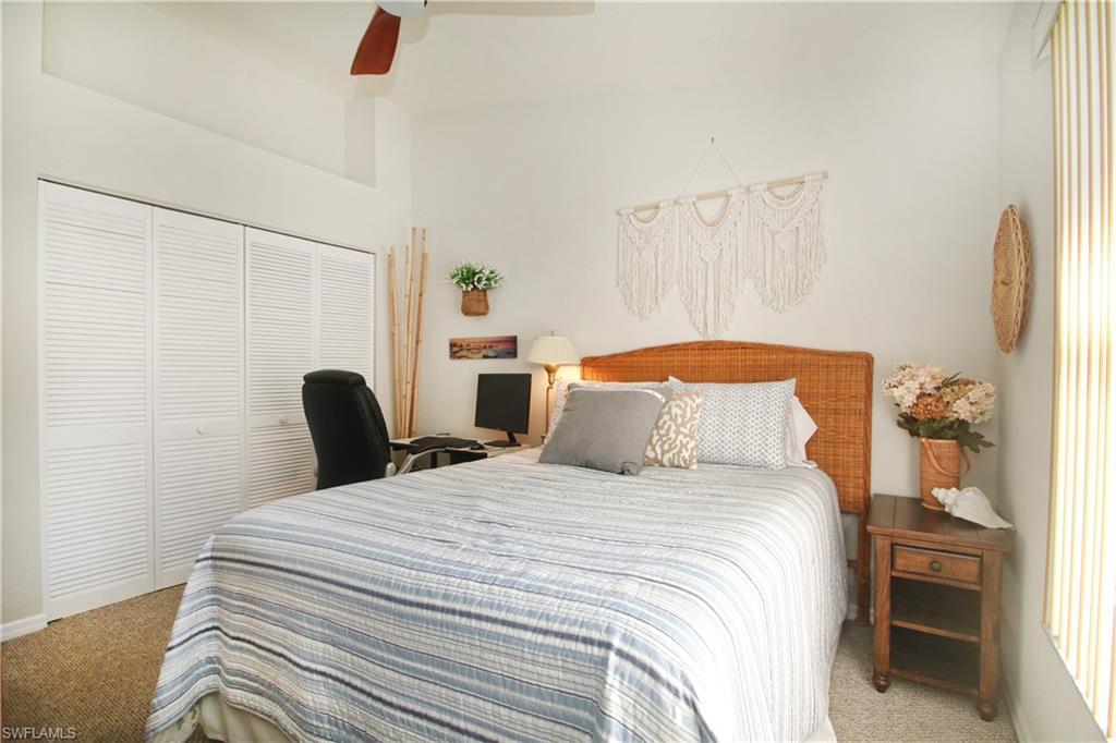 370 Emerald Bay Circle, Unit N8 Naples, FL 34110 - Photo 11 of 24 a bedroom with bed and wooden floor