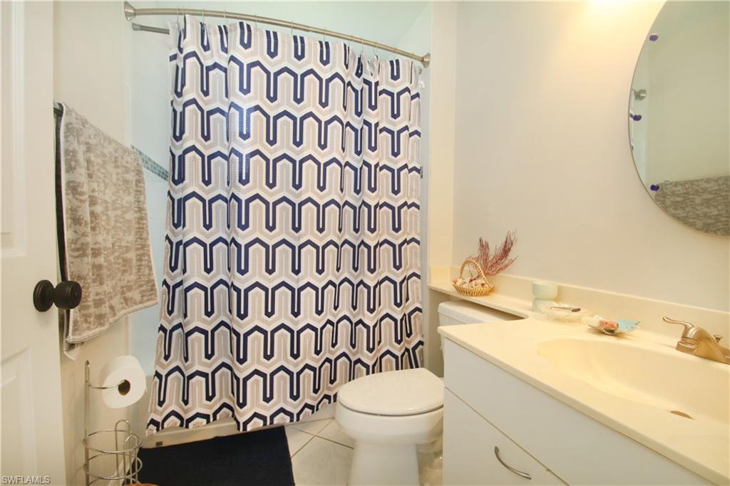 370 Emerald Bay Circle, Unit N8 Naples, FL 34110 - Photo 12 of 24 a bathroom with a sink and a mirror