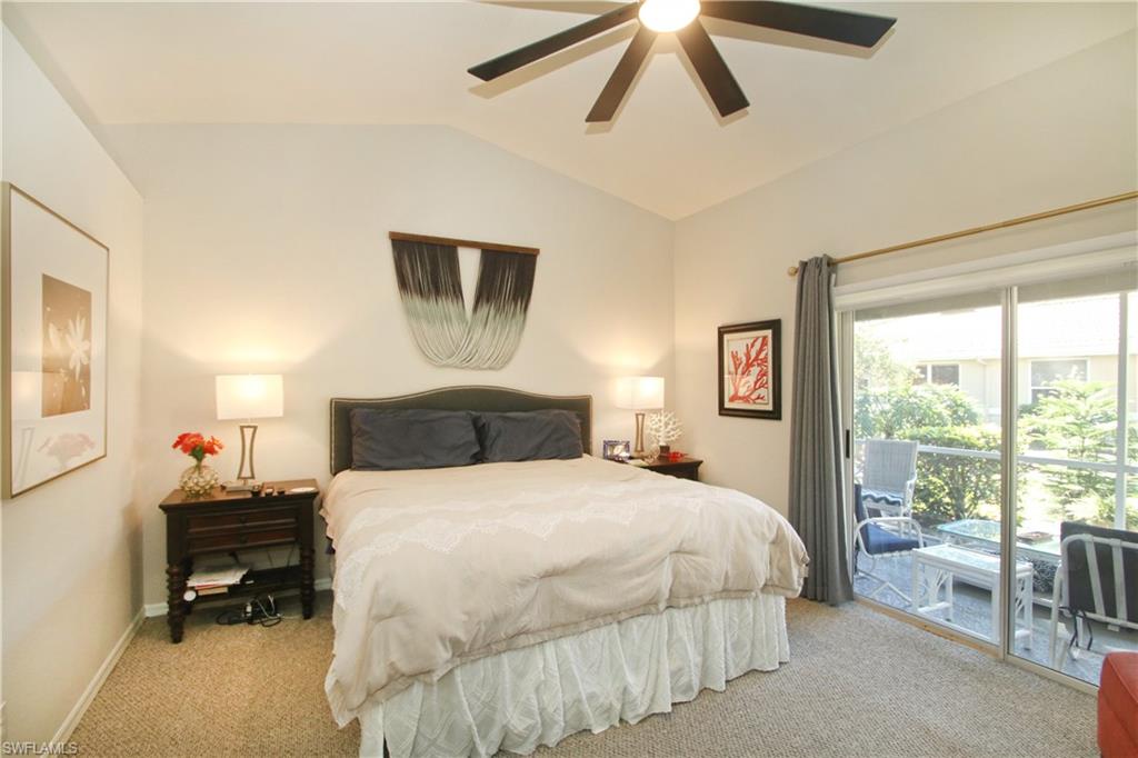 370 Emerald Bay Circle, Unit N8 Naples, FL 34110 - Photo 13 of 24 a bedroom with a bed and a window
