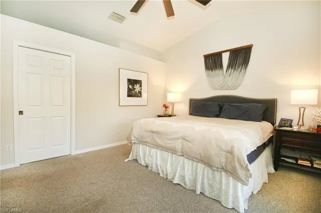 a bedroom with a bed and a painting