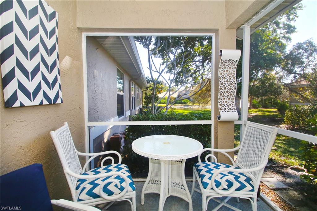 370 Emerald Bay Circle, Unit N8 Naples, FL 34110 - Photo 20 of 24 a view of a dining room with furniture a large window and wooden floor