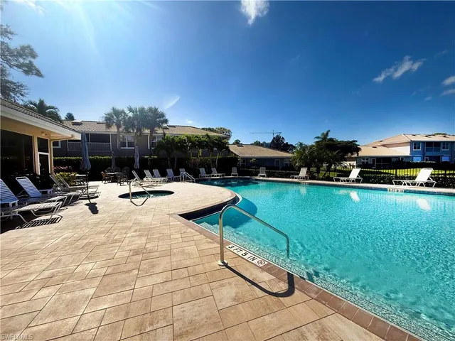 a view of swimming pool with outdoor seating and plants