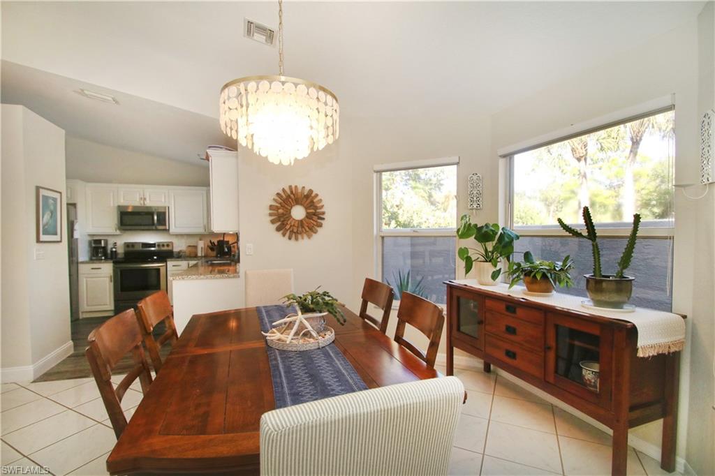 370 Emerald Bay Circle, Unit N8 Naples, FL 34110 - Photo 4 of 24 a living room with furniture kitchen view and large windows