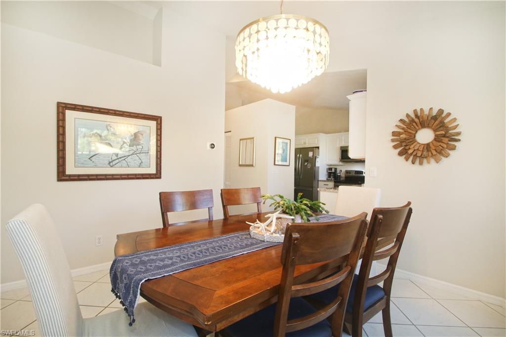 370 Emerald Bay Circle, Unit N8 Naples, FL 34110 - Photo 8 of 24 a dining room with furniture and wooden floor