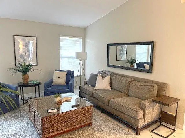 a living room with furniture and a potted plant