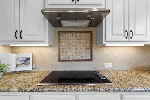 a kitchen with a stove and cabinets