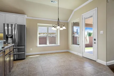 a view of a kitchen with a sink and refrigerator cabinets
