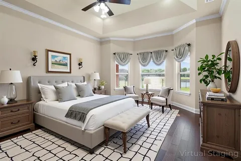 a spacious bedroom with a bed a large window with table and chairs