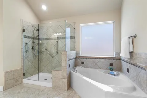 a bathroom with a bathtub and shower