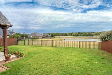 a view of a lake with houses in the background