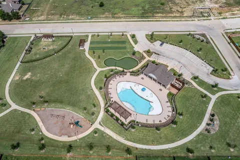 a view of a swimming pool with a lawn chairs