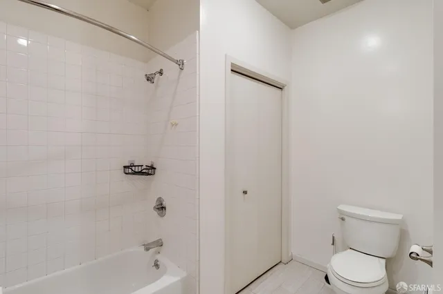 a bathroom with a toilet and shower
