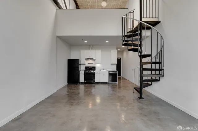 a view of a kitchen with furniture and an empty room