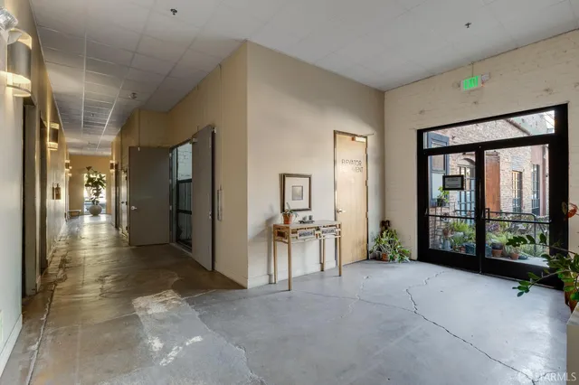 a view of building with cars parked in front of it