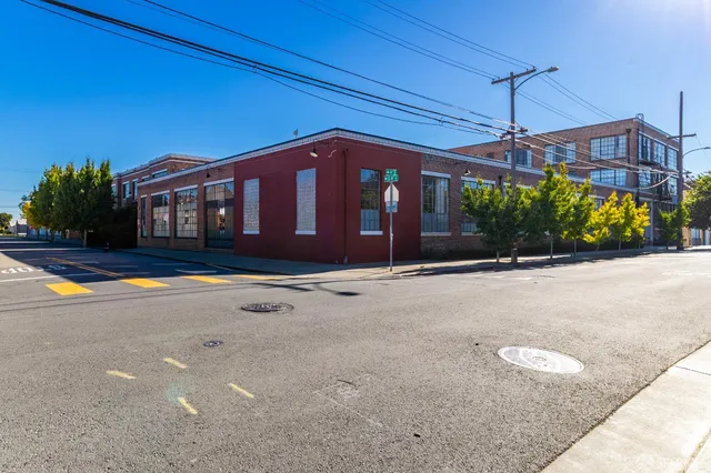 a view of a street with a building and a street sign