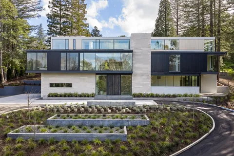 a front view of a house with a garden