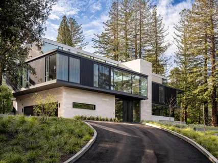 a front view of a house with a garden