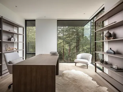 a bedroom with a bed and glass window