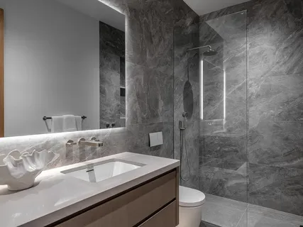 a bathroom with a sink a toilet and shower