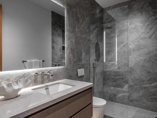 a bathroom with a sink a toilet and shower