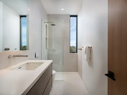 a spacious bedroom with a large bed and large windows