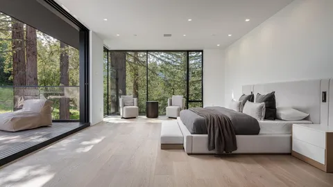 a living room with patio furniture and a potted plant