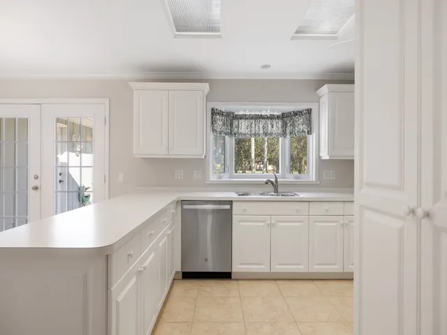 a kitchen with a sink stove and cabinets