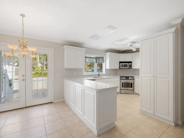 a kitchen with stainless steel appliances a sink stove and refrigerator