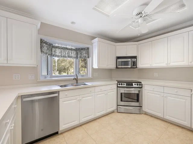 a kitchen with stainless steel appliances granite countertop a stove sink and microwave