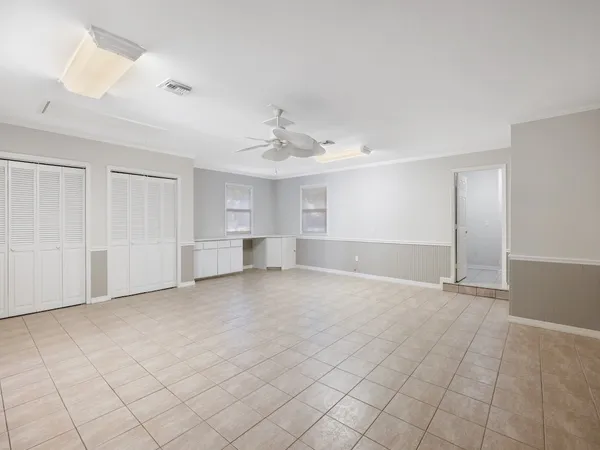 an empty room with windows and closet