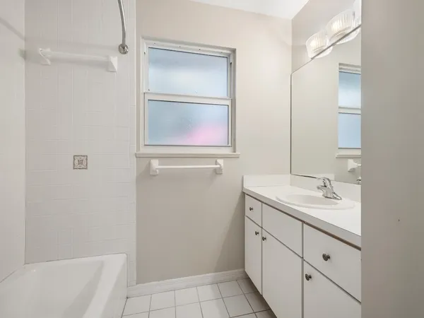 an empty room with windows and cabinet