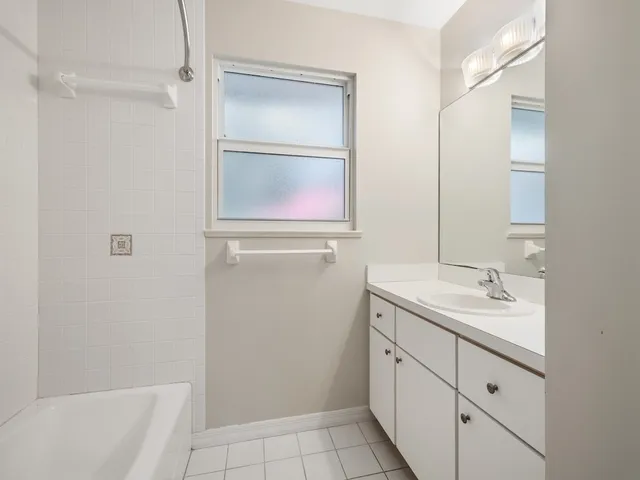 an empty room with windows and cabinet