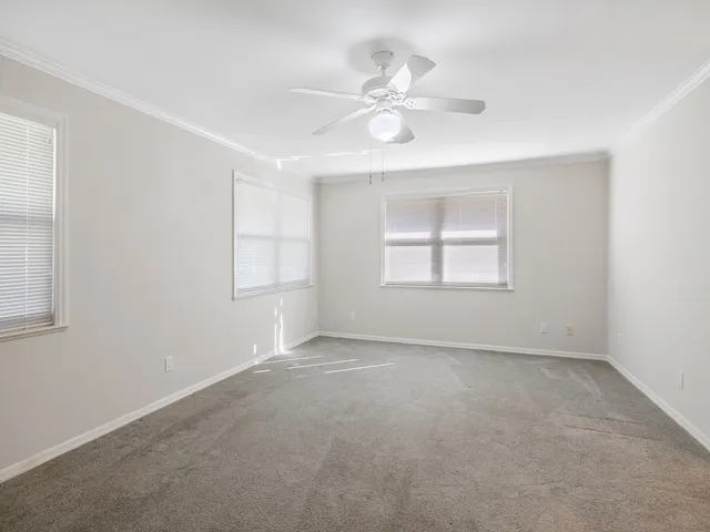 wooden floor in an empty room with a ceiling fan