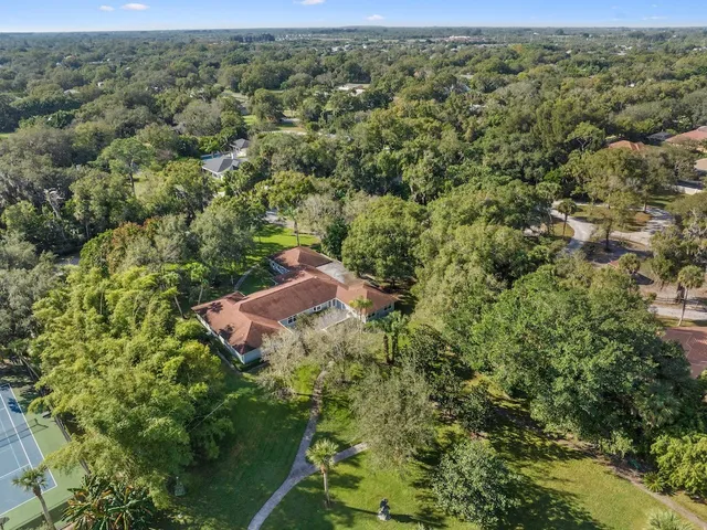 an aerial view of a house with a yard