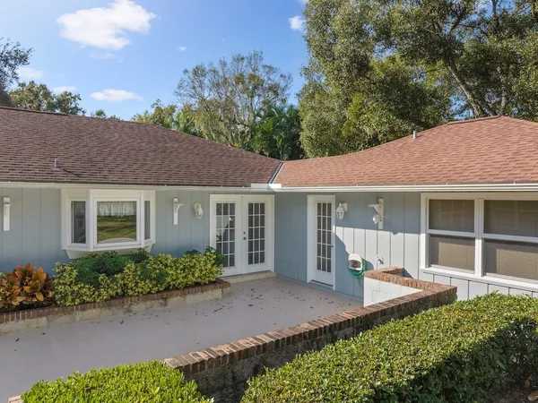 an aerial view of a house with a yard