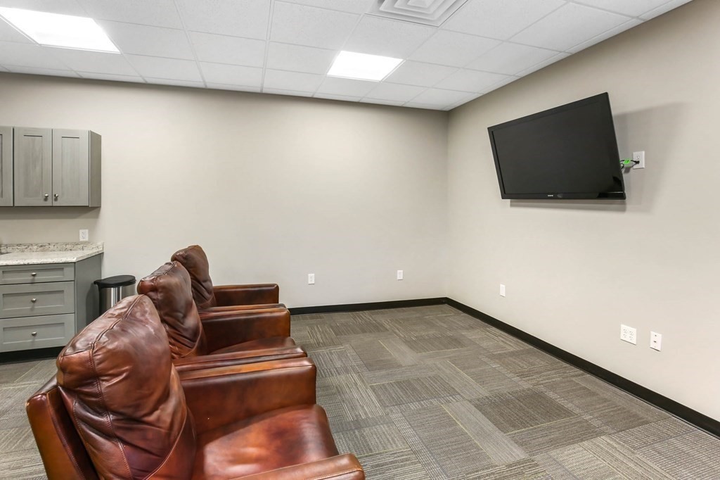 5 Harrington Street Mendon, MA 01756 - Photo 11 of 17 a living room with furniture and a flat screen tv