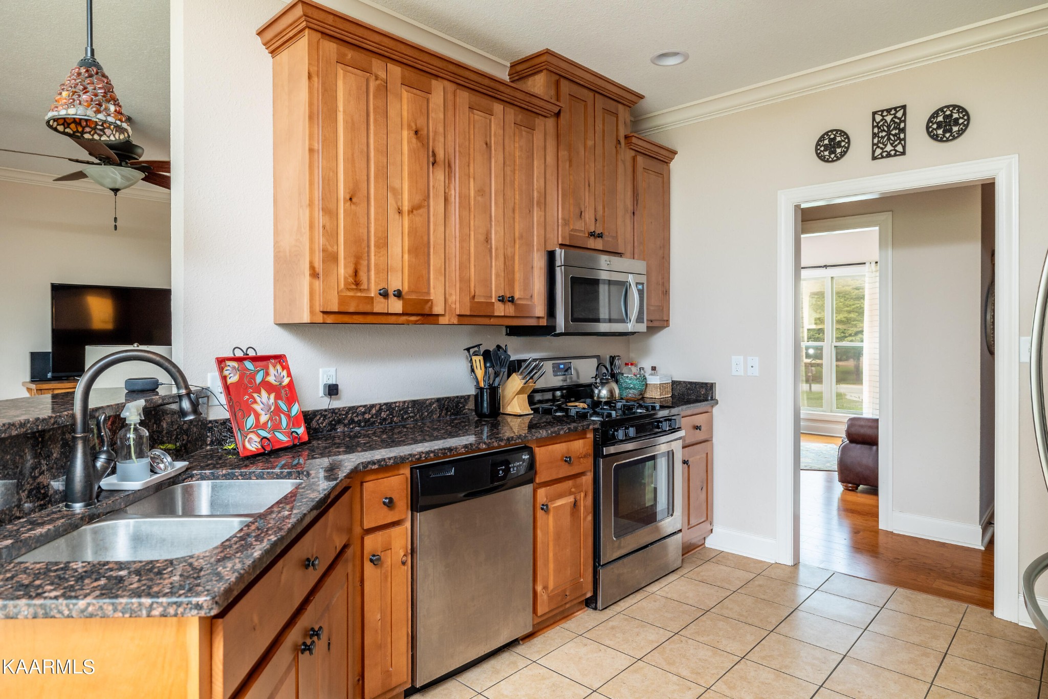 232 Riverview Road Townsend, TN 37882 - Photo 21 of 38 a kitchen with granite countertop a stove a sink and a microwave