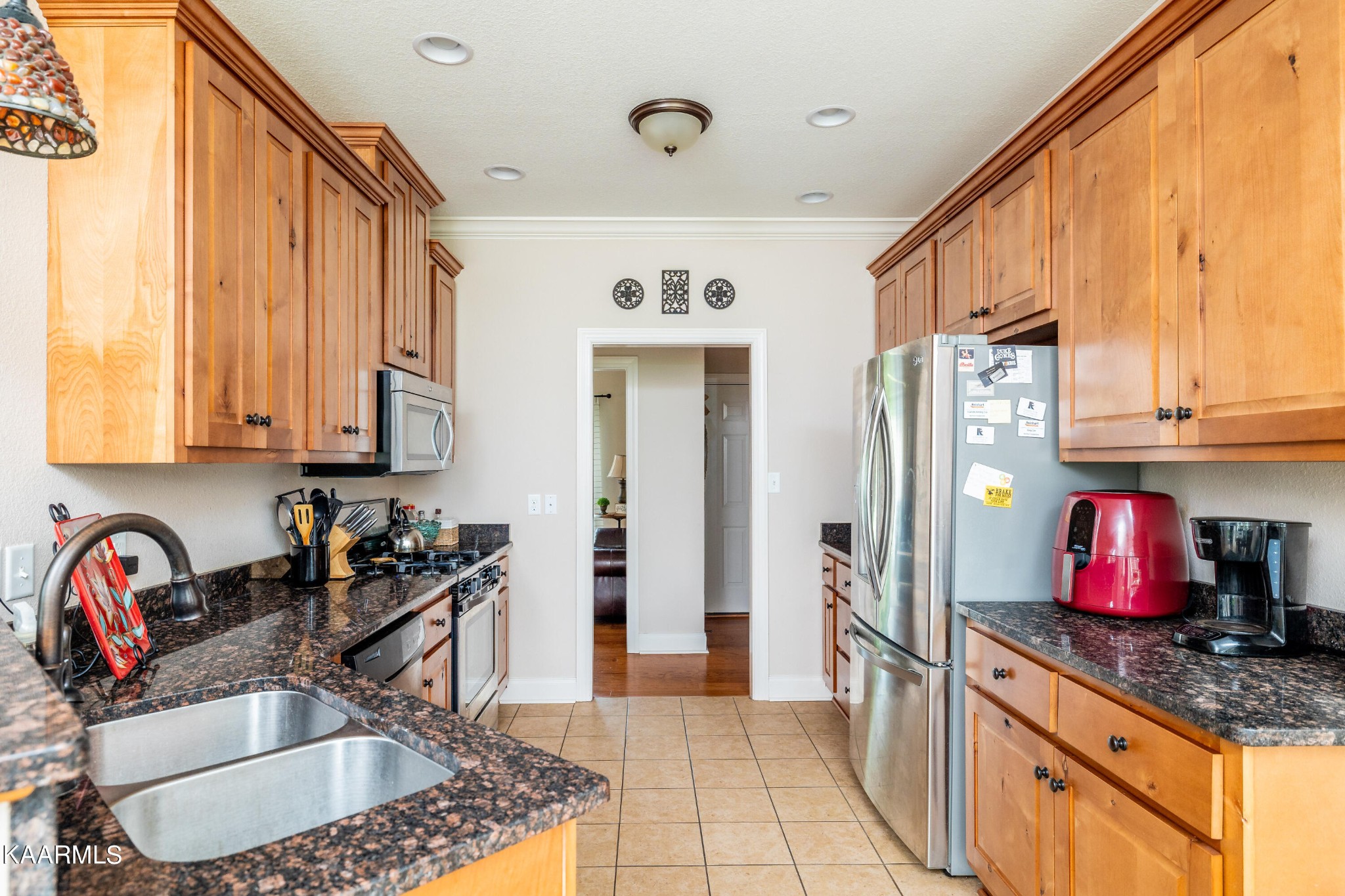 232 Riverview Road Townsend, TN 37882 - Photo 22 of 38 a kitchen with stainless steel appliances granite countertop a sink dishwasher and cabinets with wooden floor