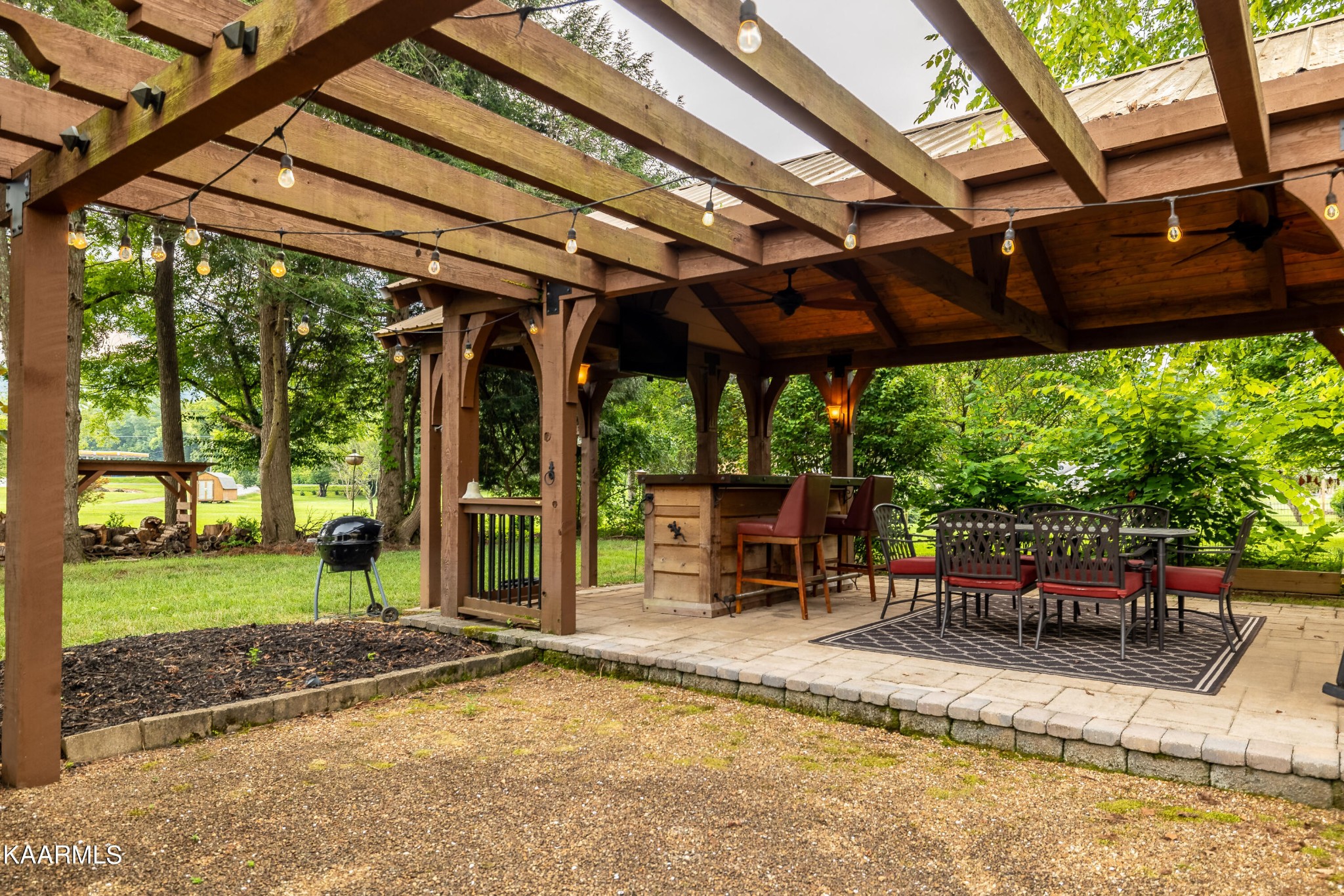 232 Riverview Road Townsend, TN 37882 - Photo 8 of 38 a view of a backyard with table and chairs under an umbrella