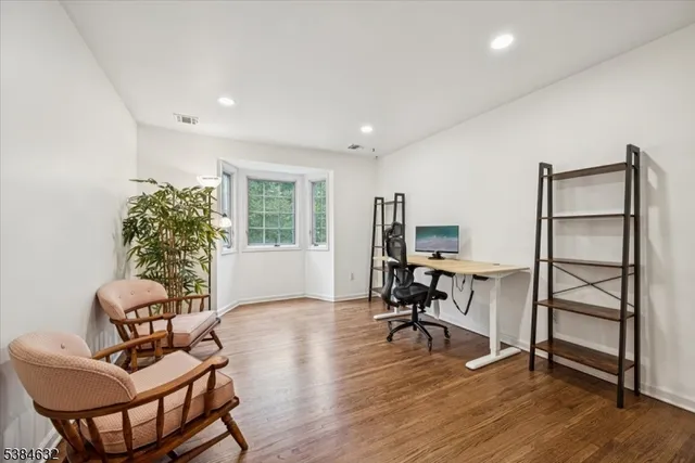 a workspace with furniture window and wooden floor