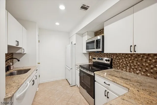a kitchen with a sink stove and microwave