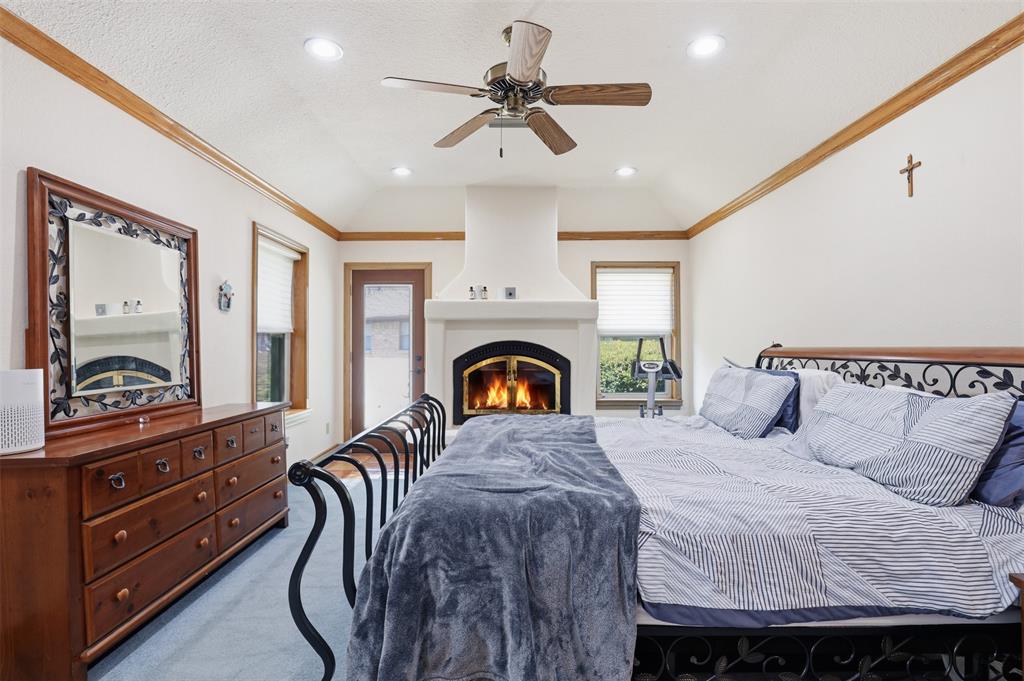 3000 Yucca Road Willow Park, TX 76087 - Photo 24 of 38 a bedroom with a large bed and a chandelier