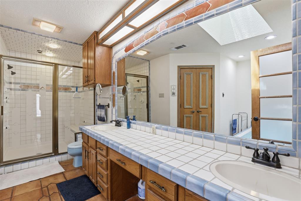 3000 Yucca Road Willow Park, TX 76087 - Photo 28 of 38 a bathroom with a double vanity sink toilet and a tub