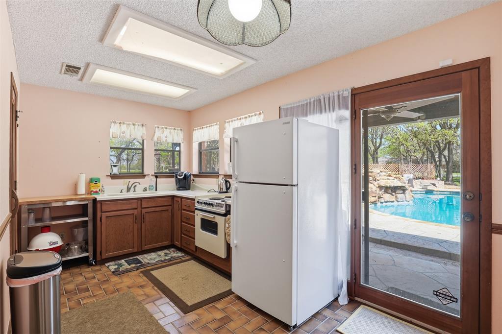3000 Yucca Road Willow Park, TX 76087 - Photo 34 of 38 a kitchen with stainless steel appliances granite countertop a refrigerator and a stove top oven