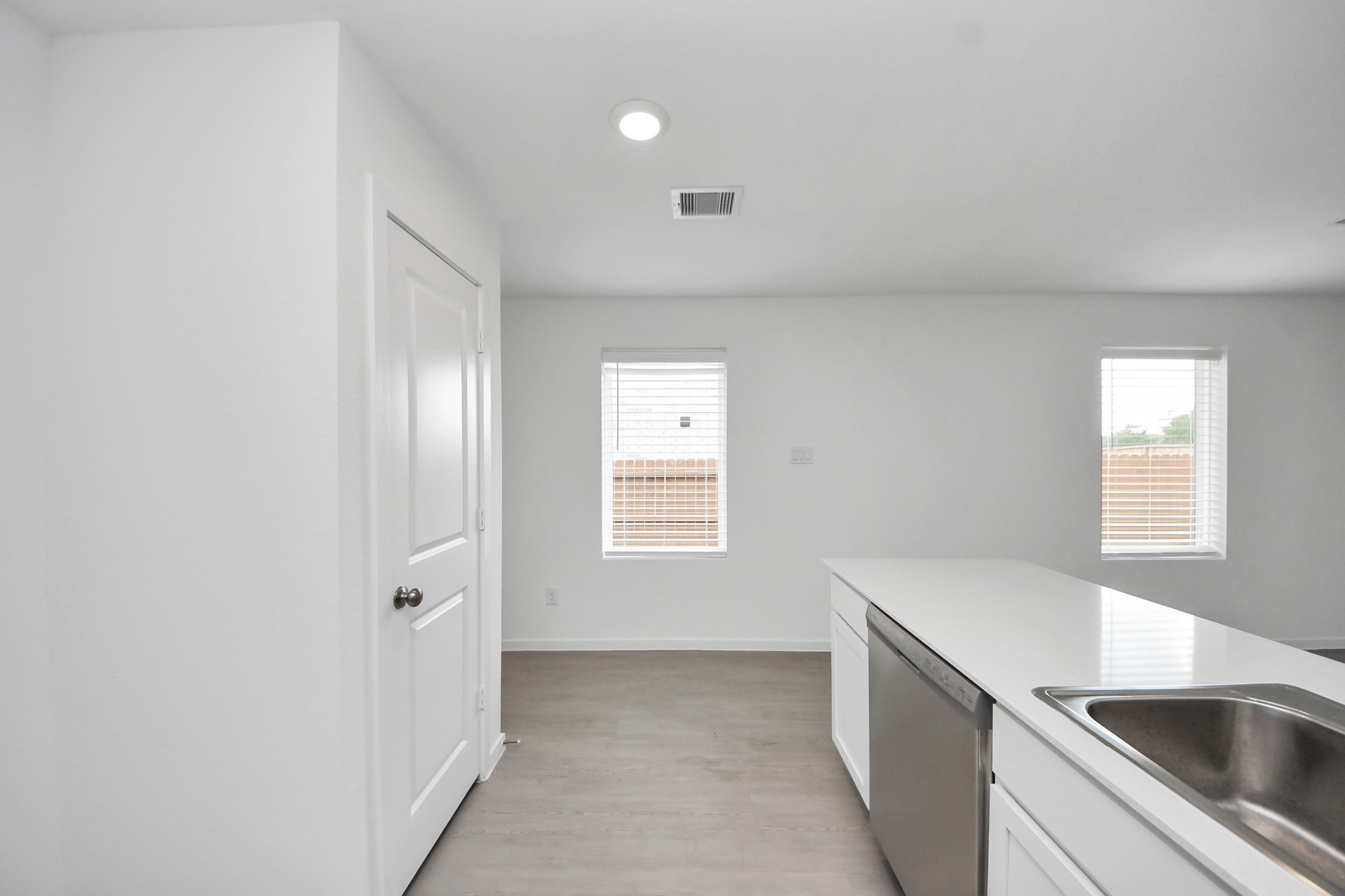 7730 Lavender Jade Drive Rosharon, TX 77583 - Photo 14 of 45 a view of a kitchen from the hallway with windows