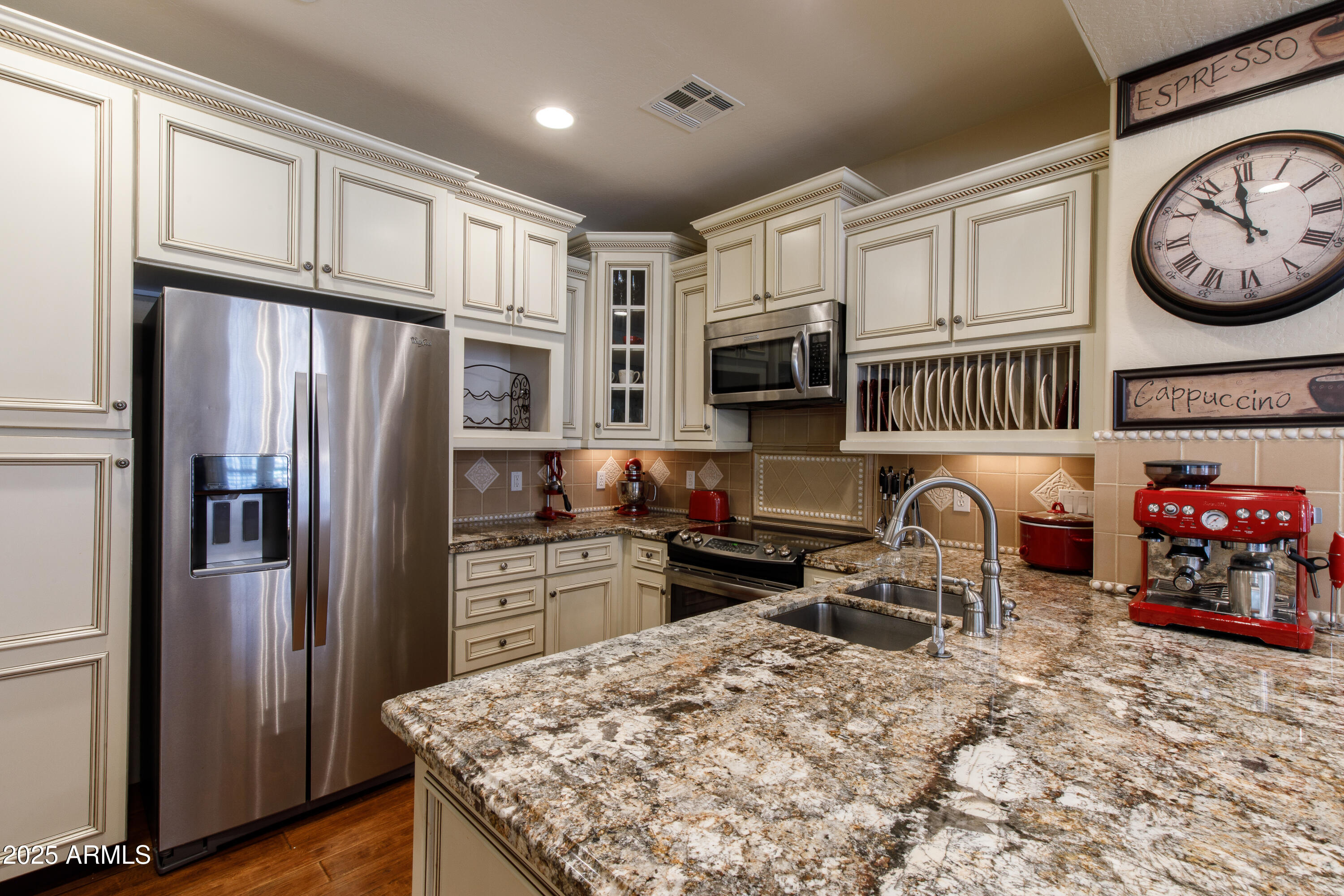 2450 East Roma Avenue, Unit 8 Phoenix, AZ 85016 - Photo 12 of 33 a kitchen with stainless steel appliances granite countertop a refrigerator stove and sink