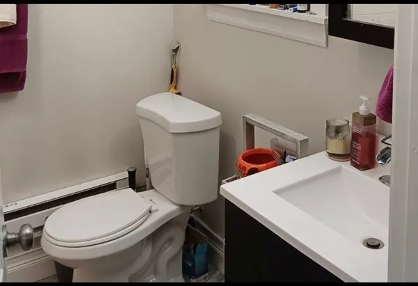 a white toilet sitting next to a bathroom sink